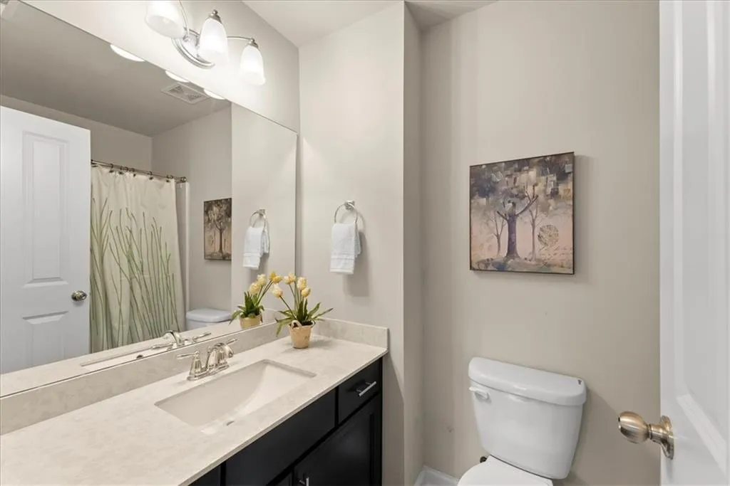 Secondary Bathroom with vanity and toilet