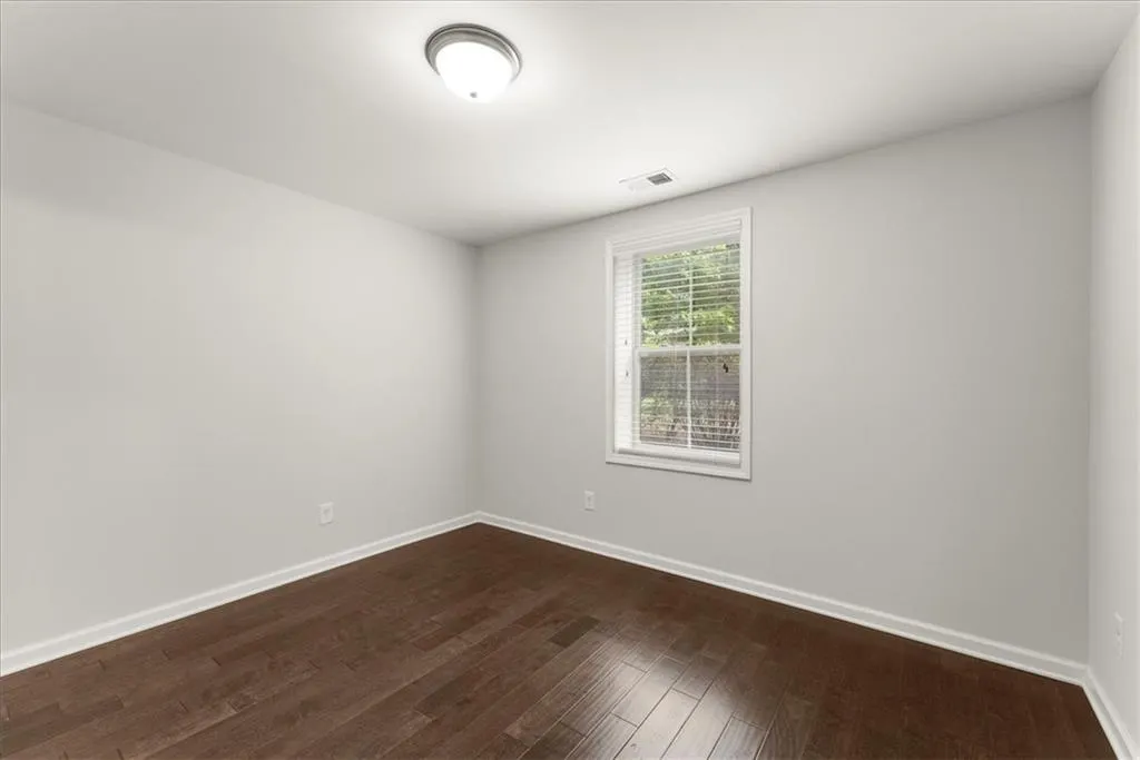 Unfurnished room featuring dark hardwood / wood-style floors