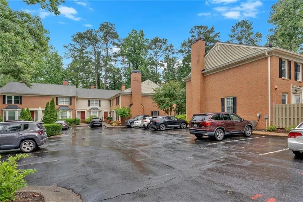 Uncovered parking lot featuring a residential view
