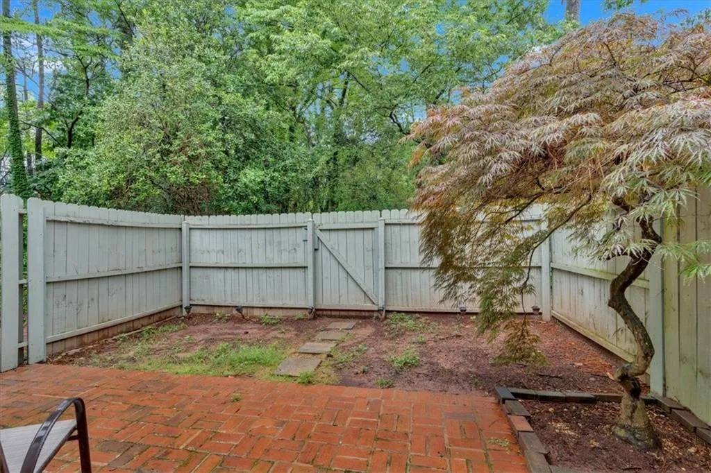 Fenced backyard with a patio and a gate