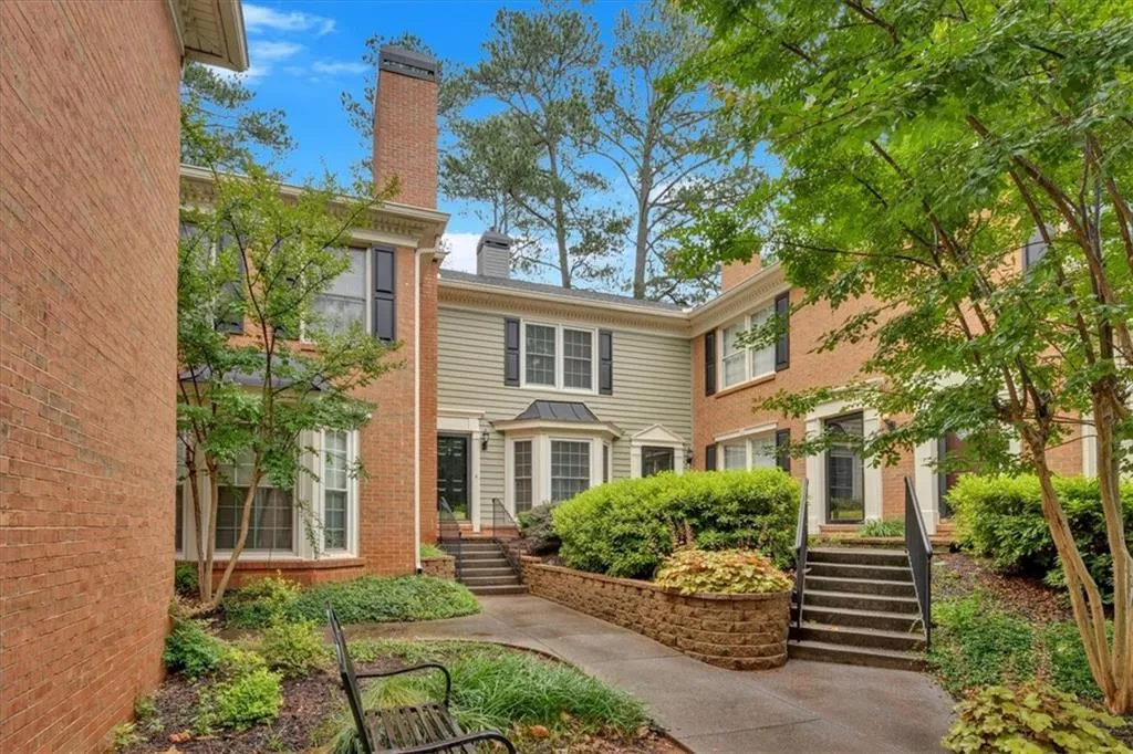 Rear view of house with a chimney and brick siding