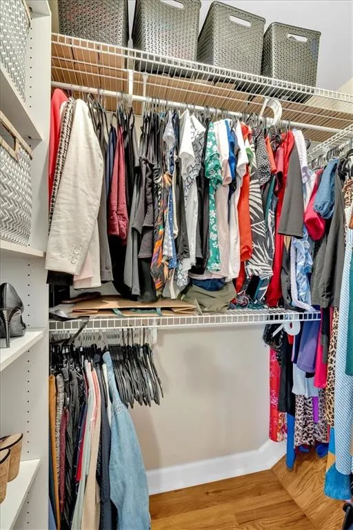 Spacious closet featuring wood finished floors