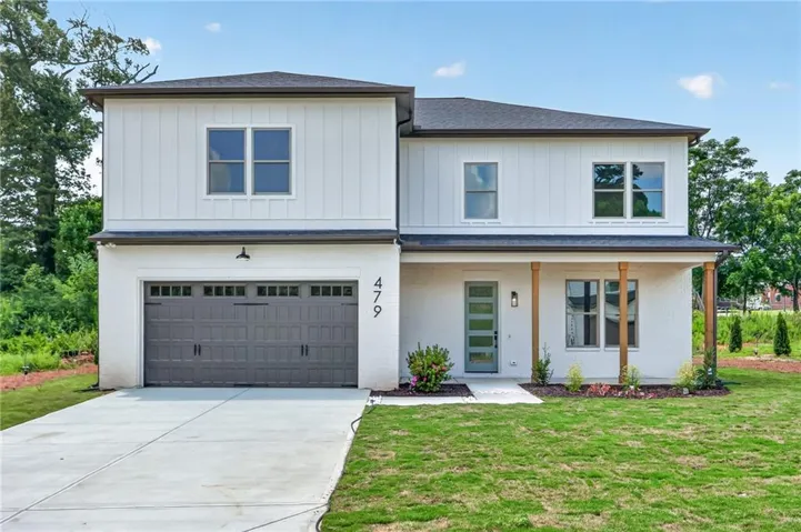 Modern exterior featuring white painted brick and vertical siding