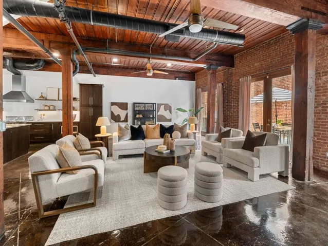 Exposed brick walls, wood-beam ceilings, and polished concrete flooring