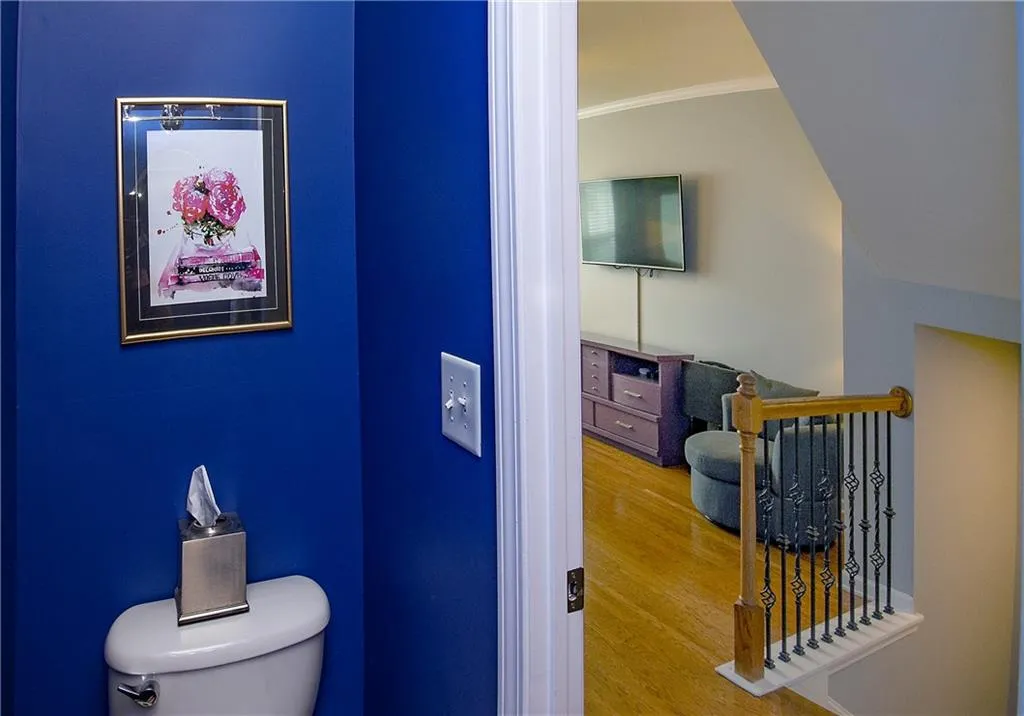 Bathroom featuring crown molding and wood finished floors