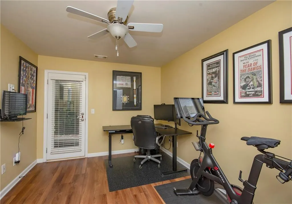 Home office featuring wood finished floors and a ceiling fan
