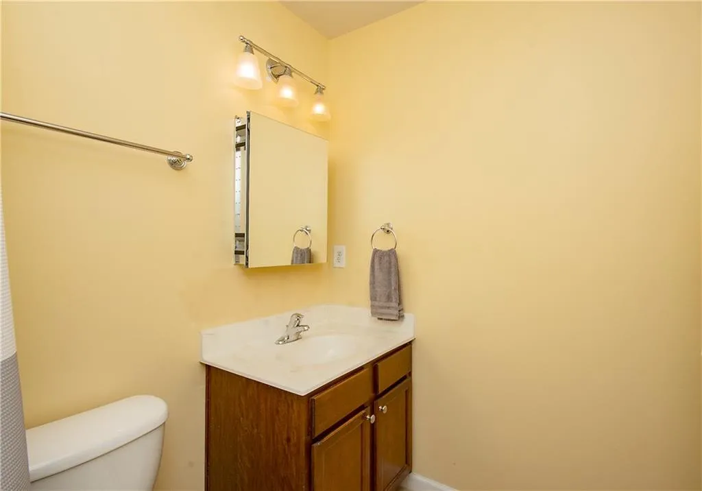 Half bathroom featuring toilet and vanity