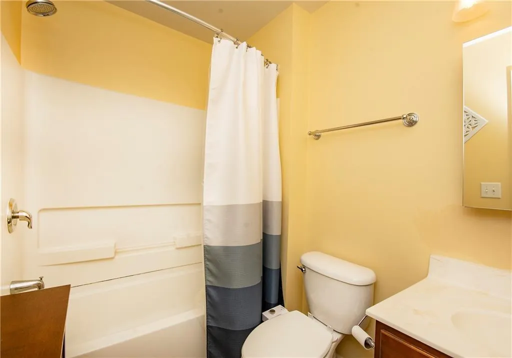 Bathroom with vanity and shower / tub combo with curtain
