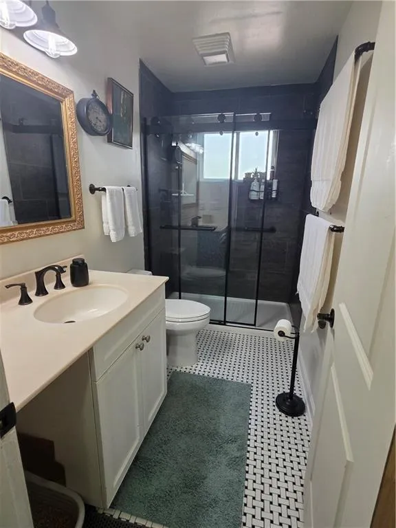 Bathroom featuring vanity and a stall shower