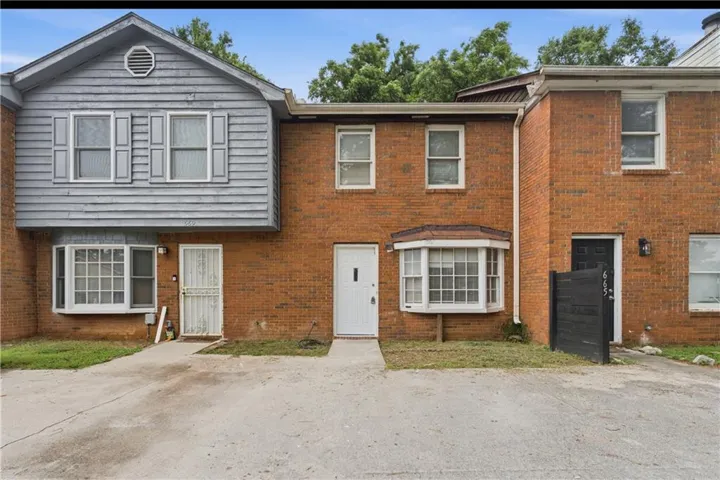 Brick and siding exterior featuring multiple window styles