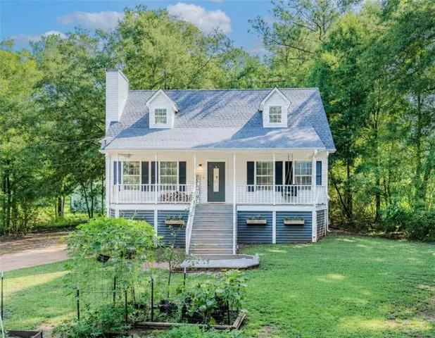 White siding exterior with a dark blue foundation and white trim