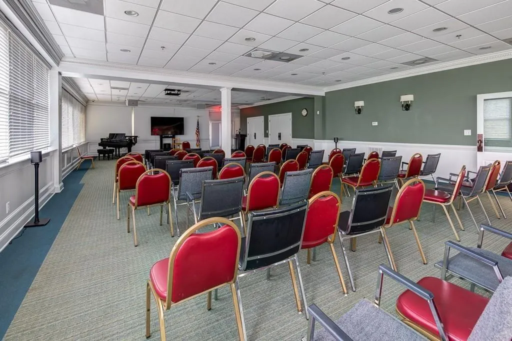 Carpeted cinema room with a paneled ceiling and crown molding