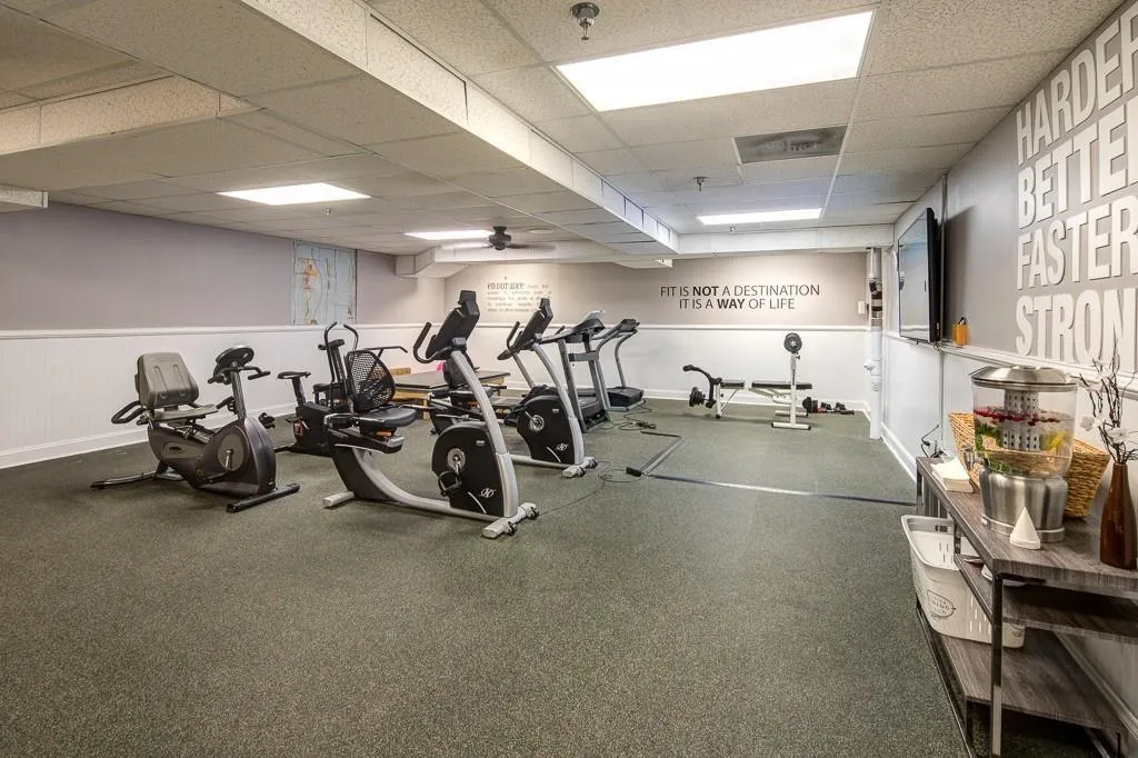 Exercise room with a drop ceiling and ceiling fan