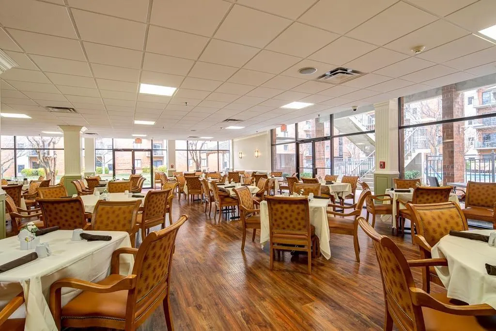 Dining area with floor to ceiling windows and wood-type flooring
