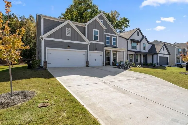 Contemporary two-story residence featuring a gray vertical siding and white trim exterior