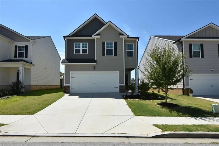 Two-story residence featuring a gray and dark gray facade with white trim