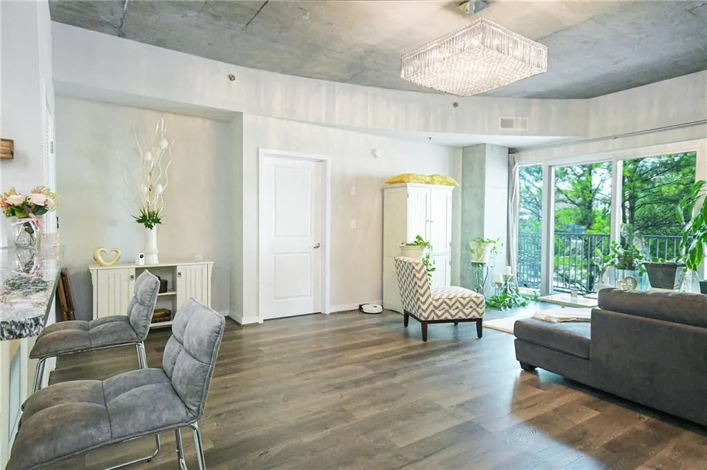 Living room featuring wood finished floors and a chandelier
