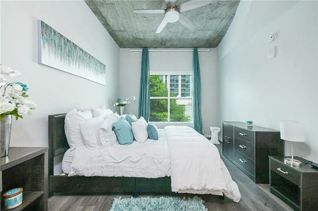 Bedroom featuring wood finished floors and a ceiling fan