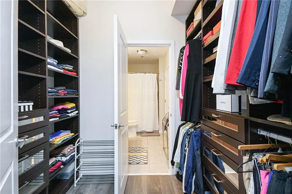 Walk in closet featuring wood finished floors