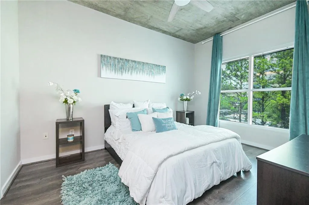 Bedroom with dark wood-style floors and a ceiling fan