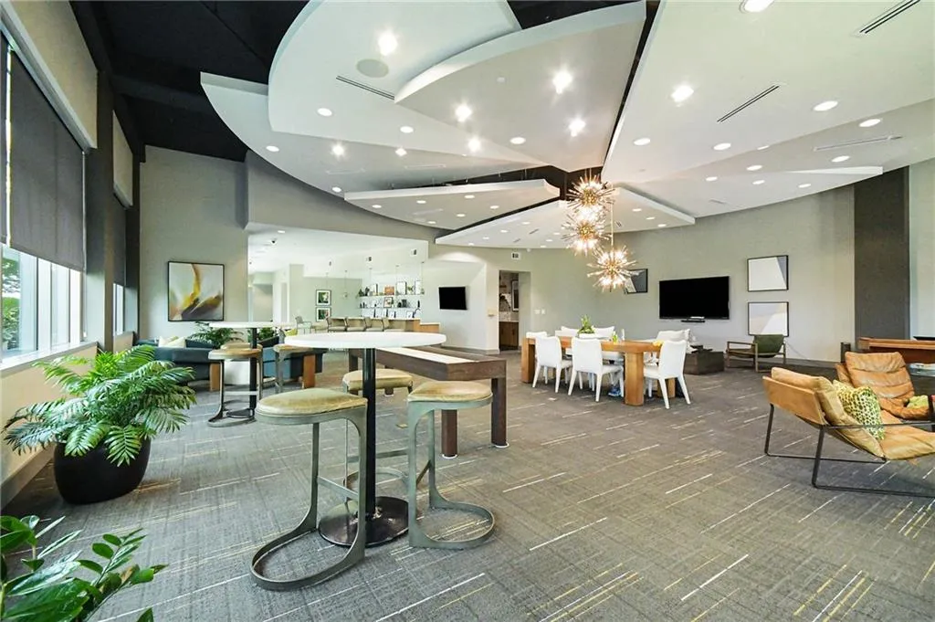 Carpeted dining room featuring recessed lighting and a chandelier