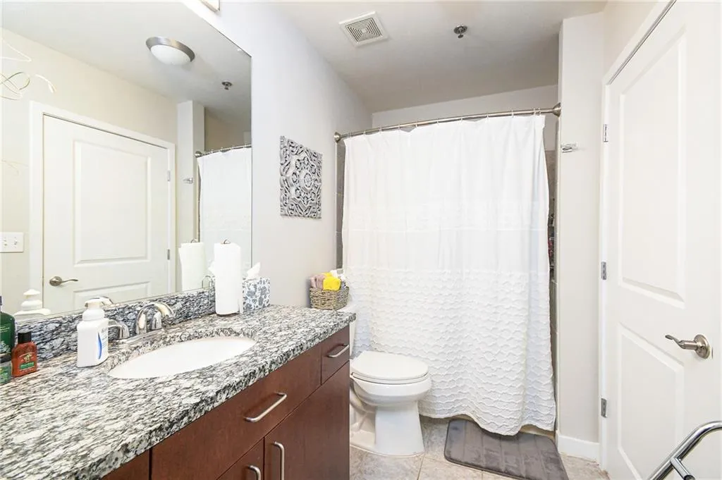 Bathroom featuring tile patterned floors and vanity