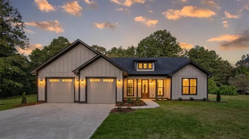 Modern farmhouse architecture with vertical siding, gabled rooflines, and a covered entry