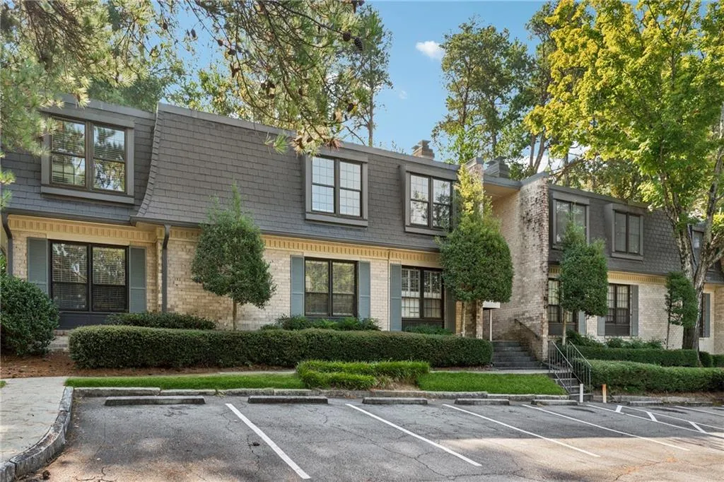 View of front of property featuring brick siding and uncovered parking