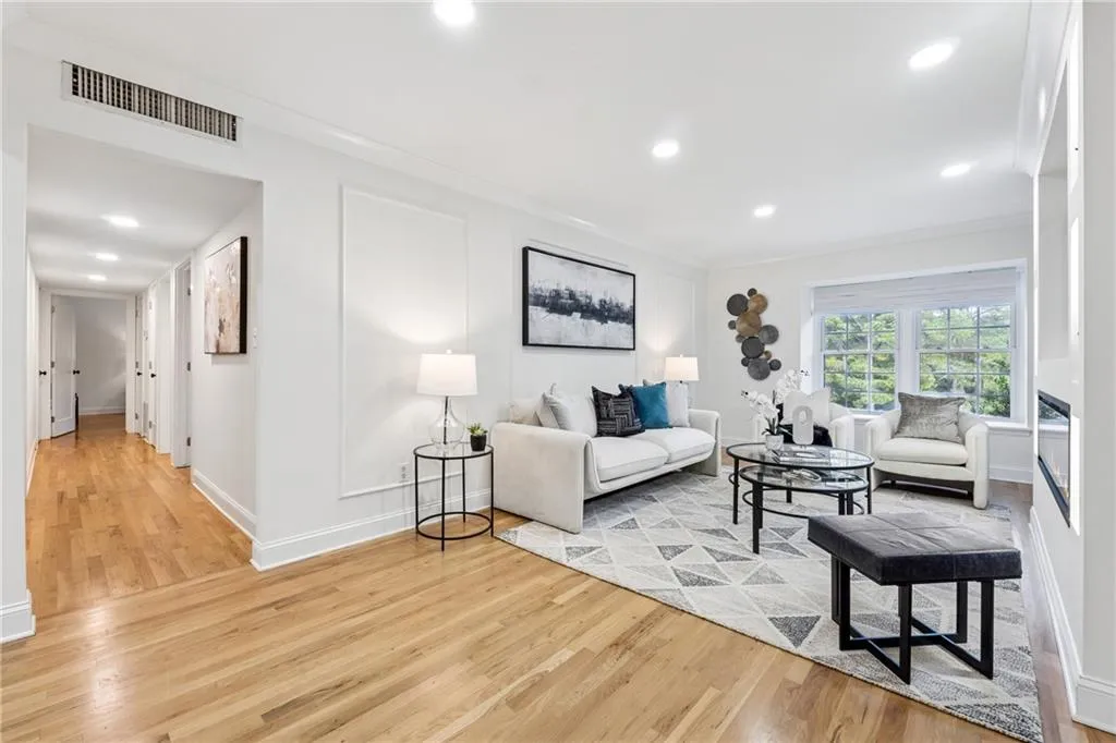 Living room with light wood finished floors, recessed lighting, and crown molding
