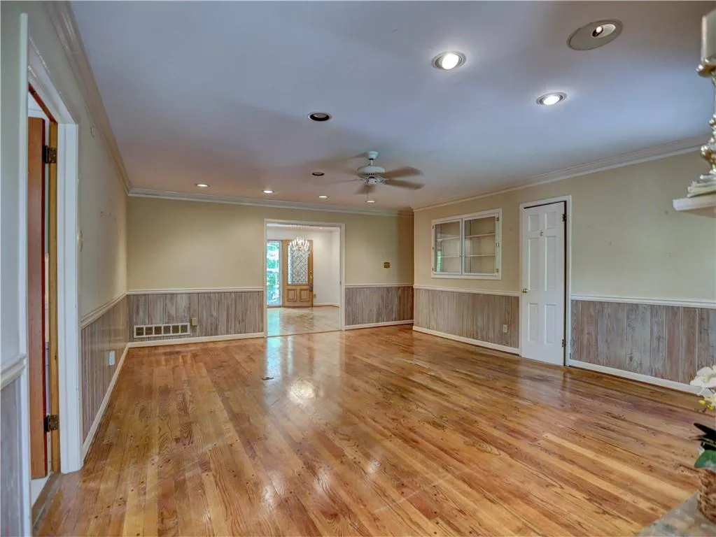 Spare room with ceiling fan, light hardwood / wood-style floors, and crown molding