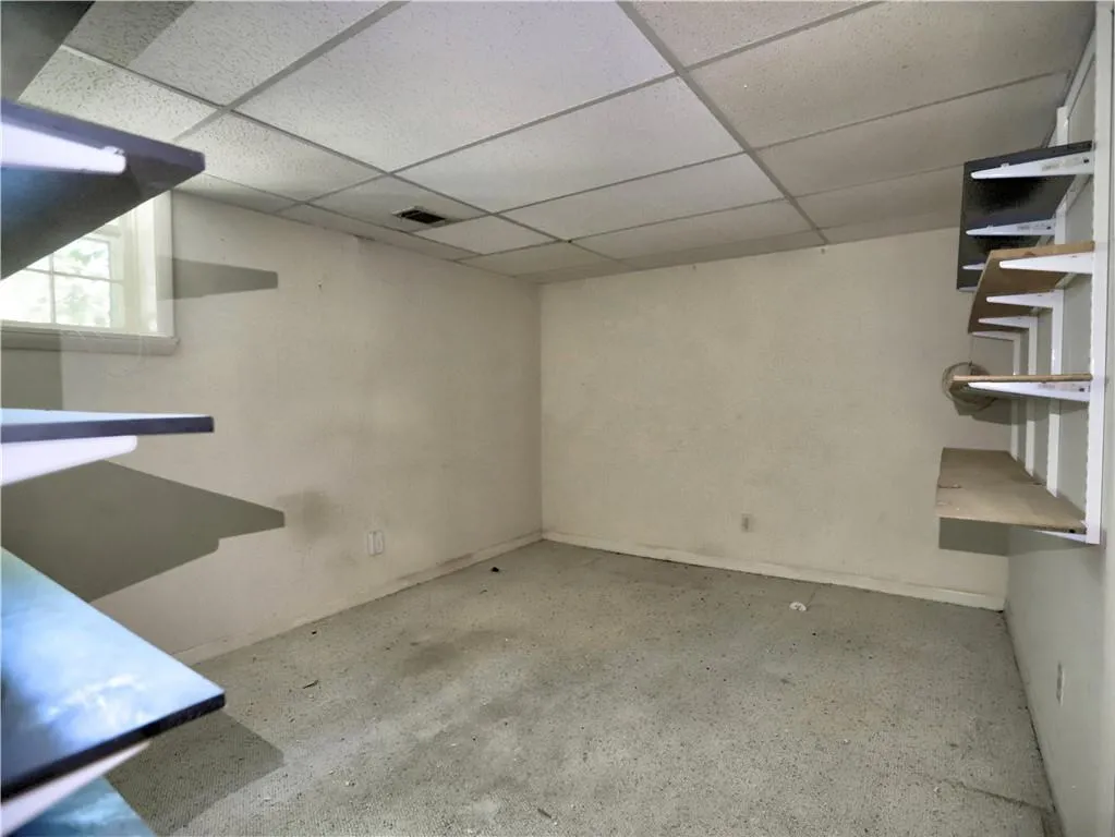 Basement with a paneled ceiling