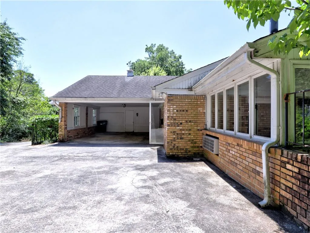 View of side of property with a carport