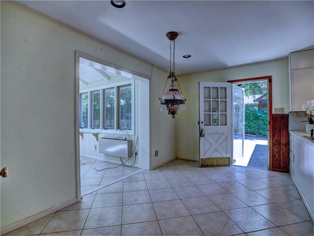 Unfurnished dining area featuring light tile floors
