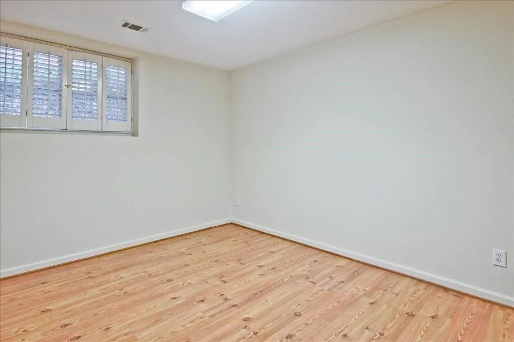 Empty room featuring wood finished floors and baseboards