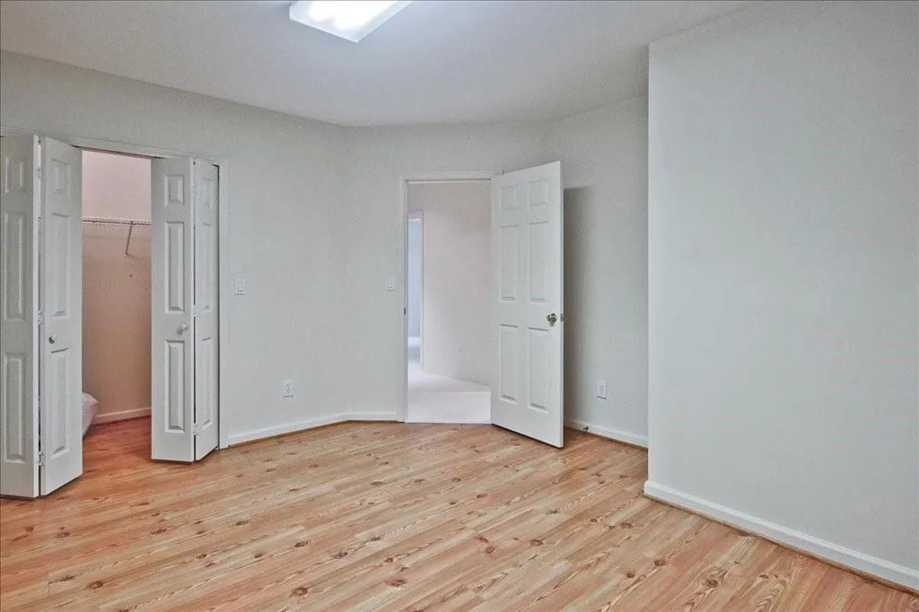 Unfurnished bedroom featuring light wood finished floors and a closet