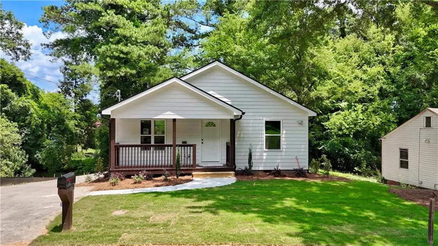 White siding exterior with a dark trim roofline