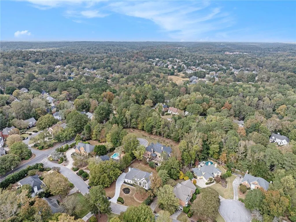 View of property location with nearby suburban area and a forest