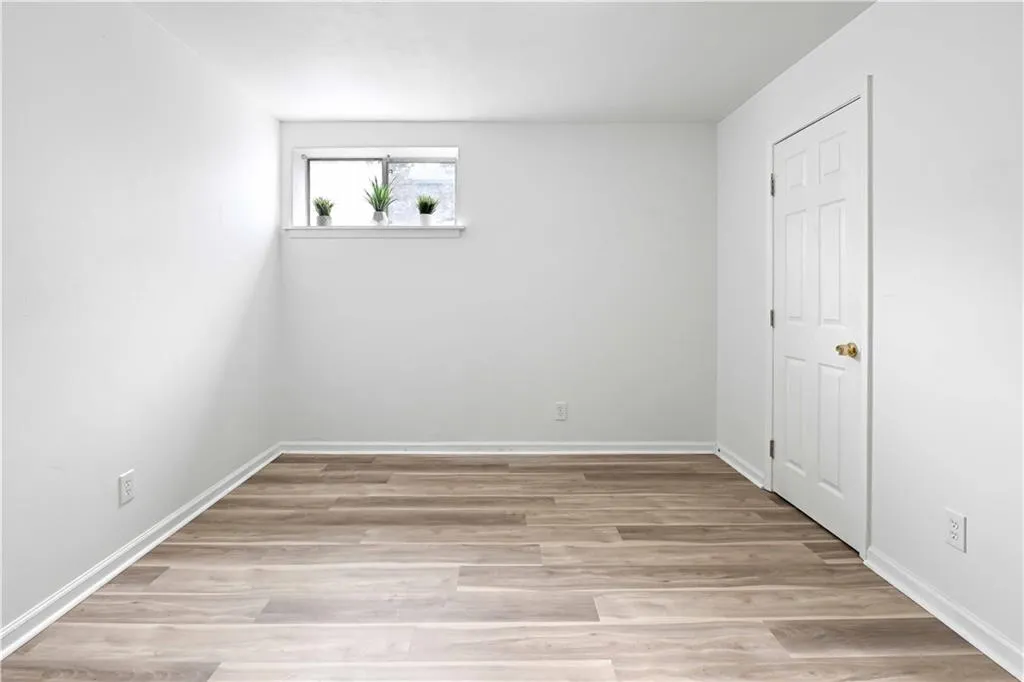Unfurnished bedroom with light wood-style floors and baseboards