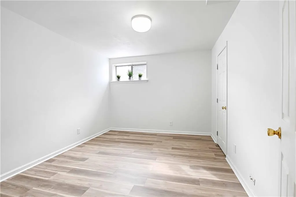 Empty room with light wood-style floors and baseboards