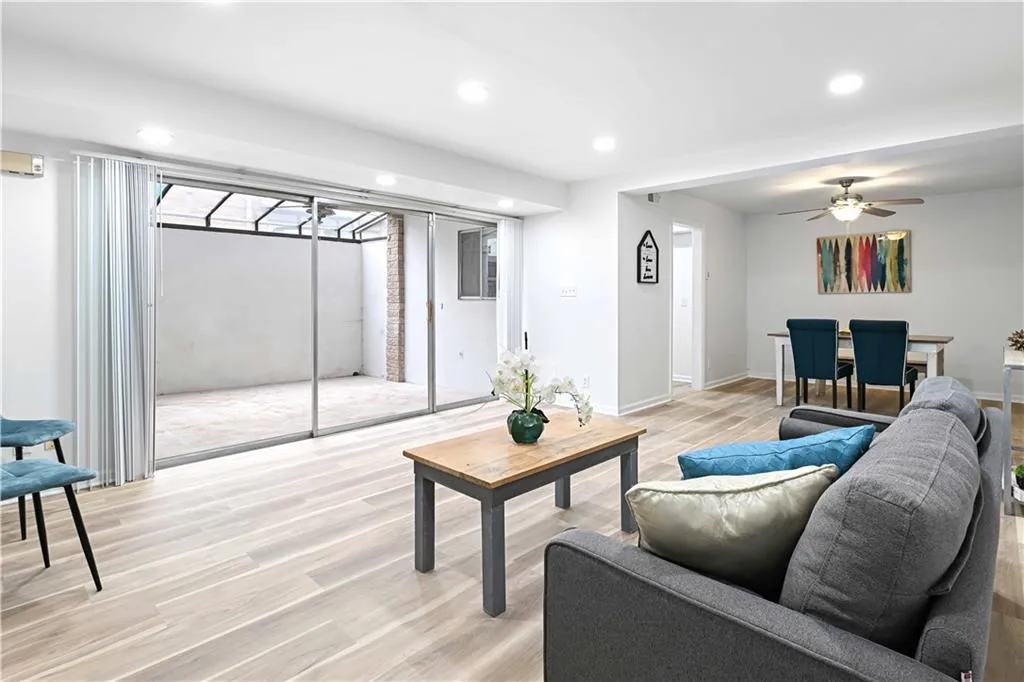 Living area with light wood finished floors, recessed lighting, and ceiling fan