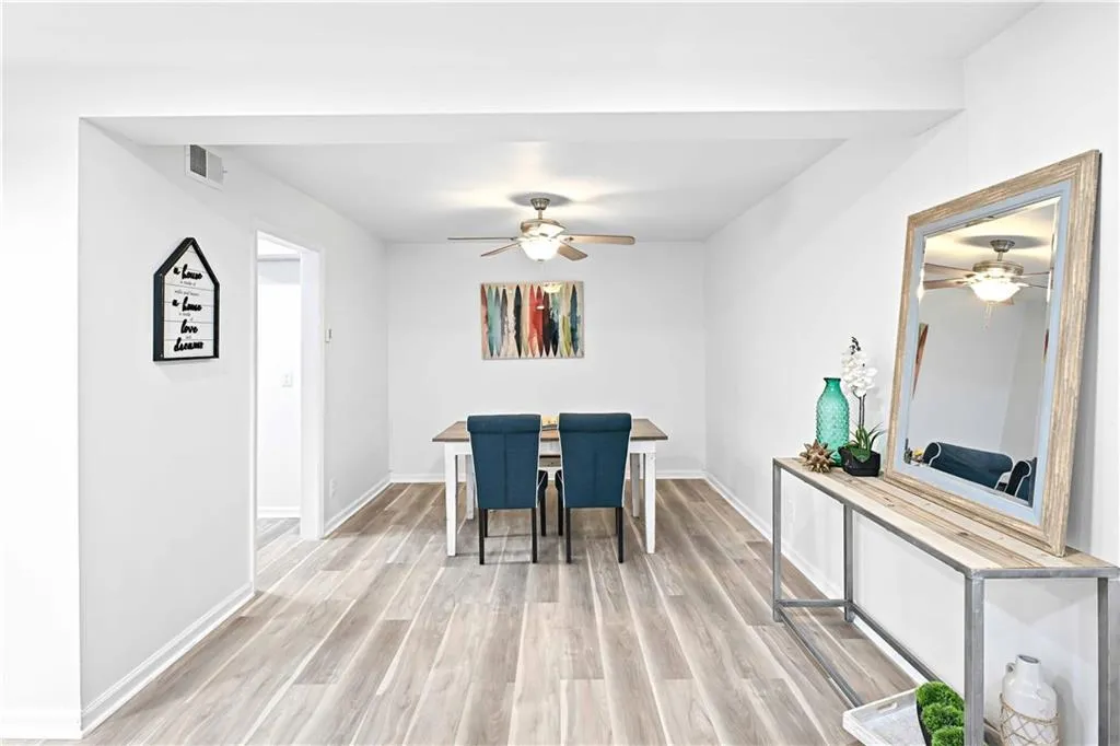 Dining area with light wood-style flooring and a ceiling fan