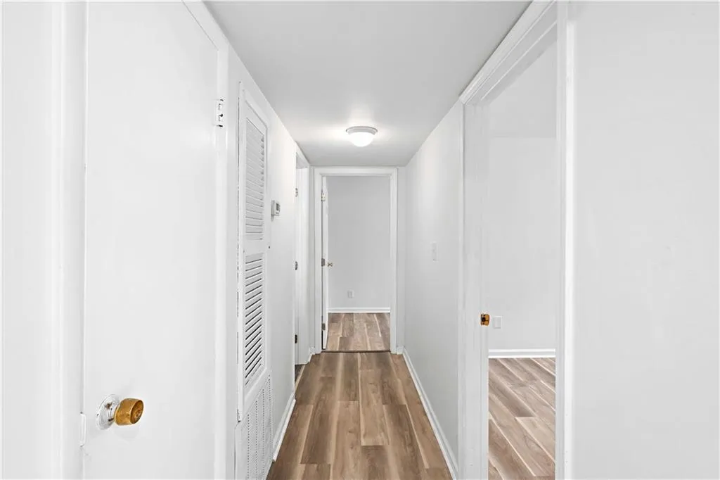 Hallway with wood finished floors and baseboards