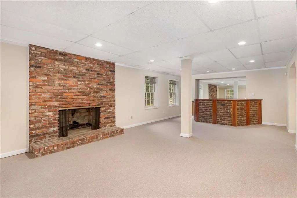 Huge finished space in the daylight basement with fireplace and built in bar.