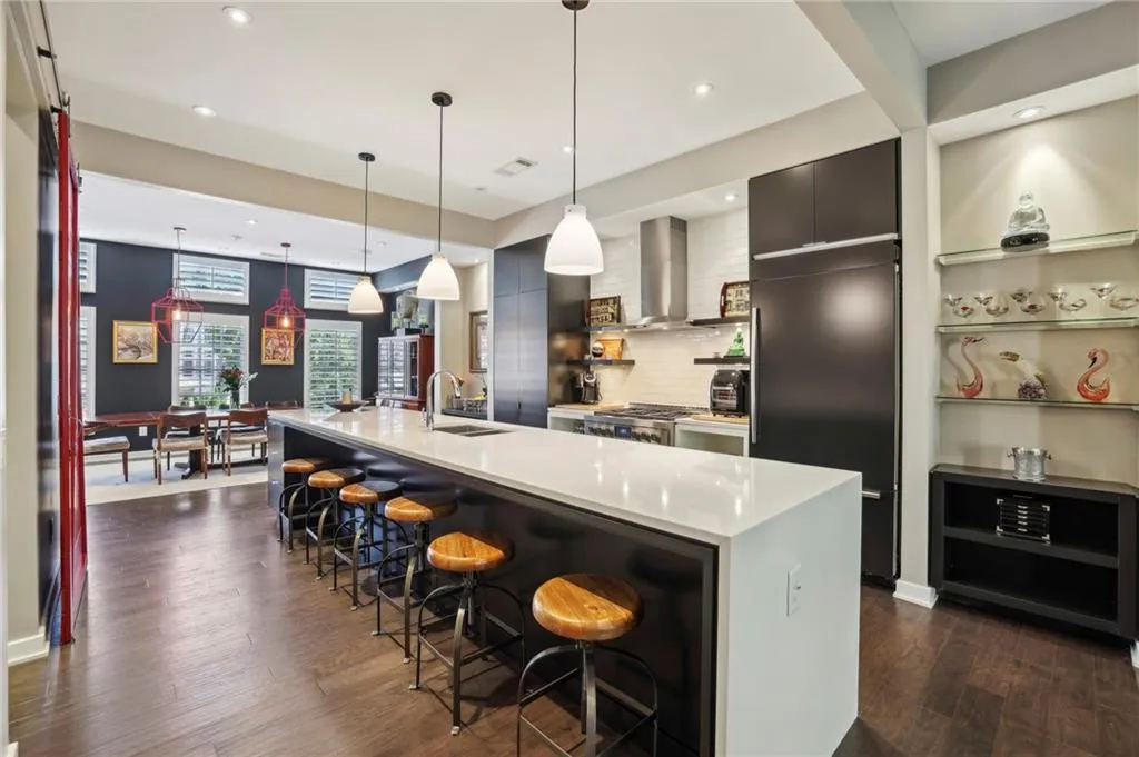 Kitchen has 6-burner gas cooktop with vented hood and plenty of room to host the largest of family soirees.