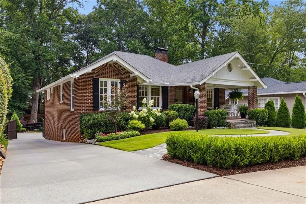 Brick exterior residence with a covered front porch featuring white columns