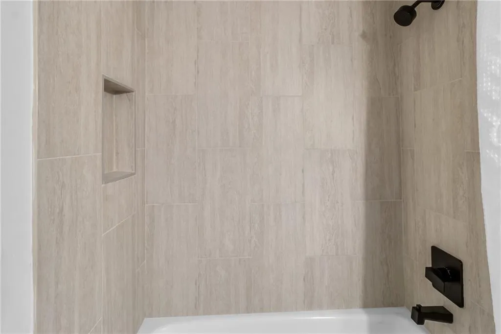 Bathroom view of shower / bathtub combination
