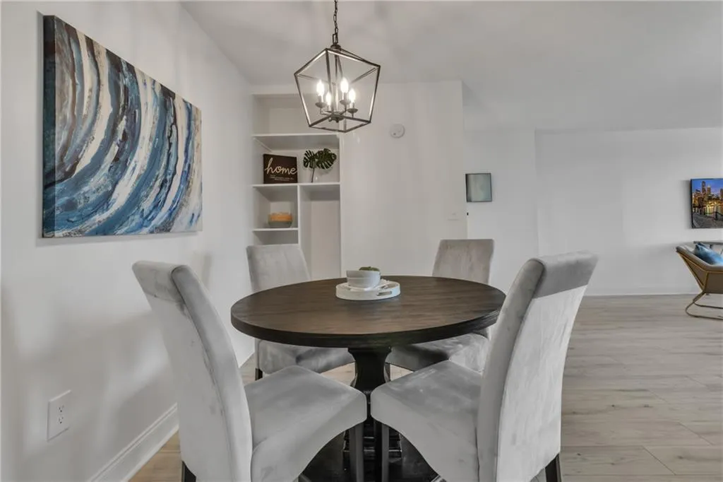 Dining area with a chandelier and wood finished floors