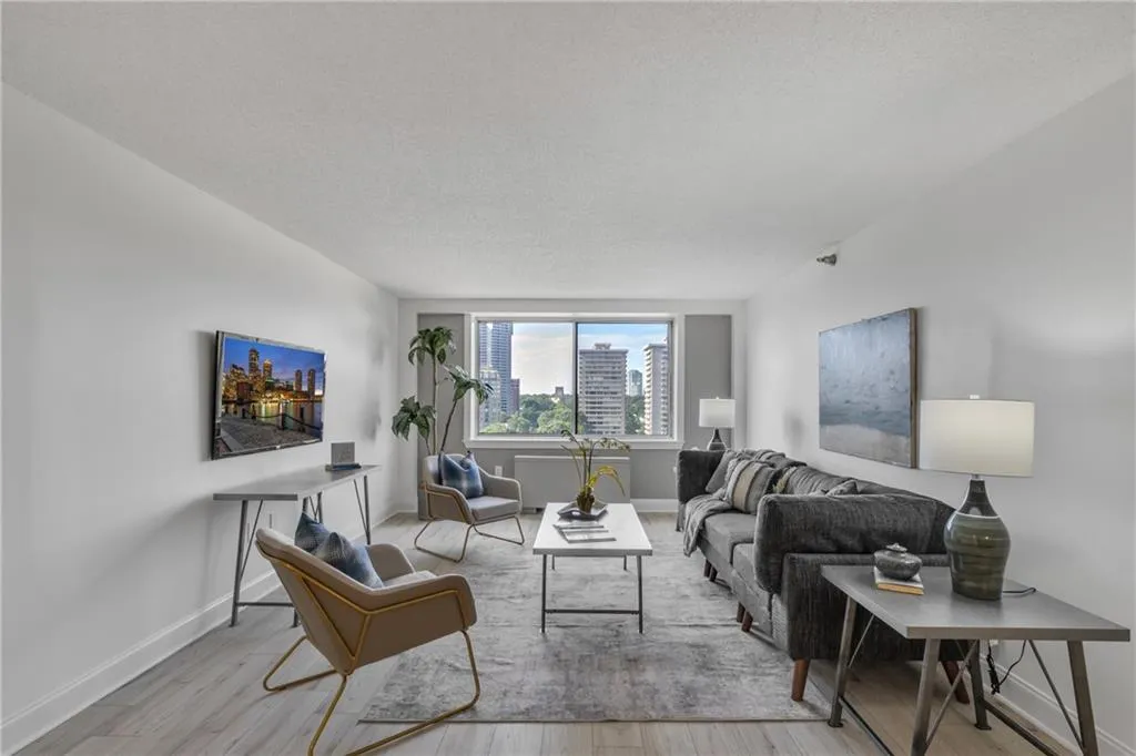 Living area with wood finished floors and a textured ceiling