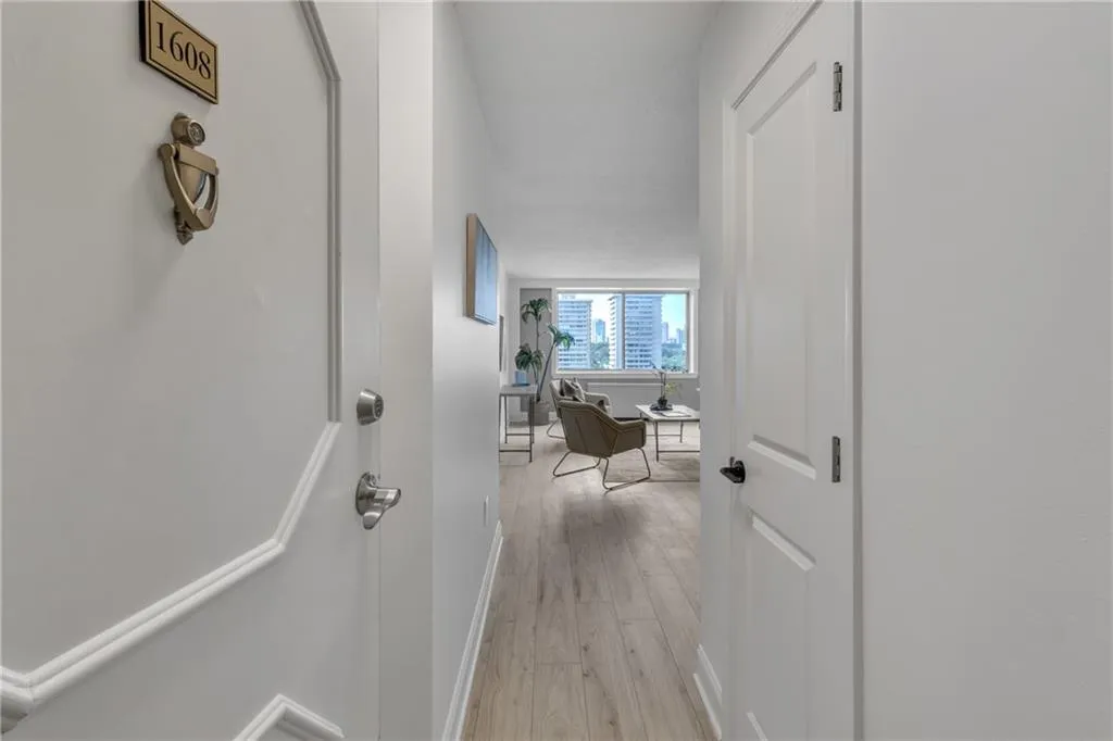 Hallway featuring light wood-style flooring and baseboards