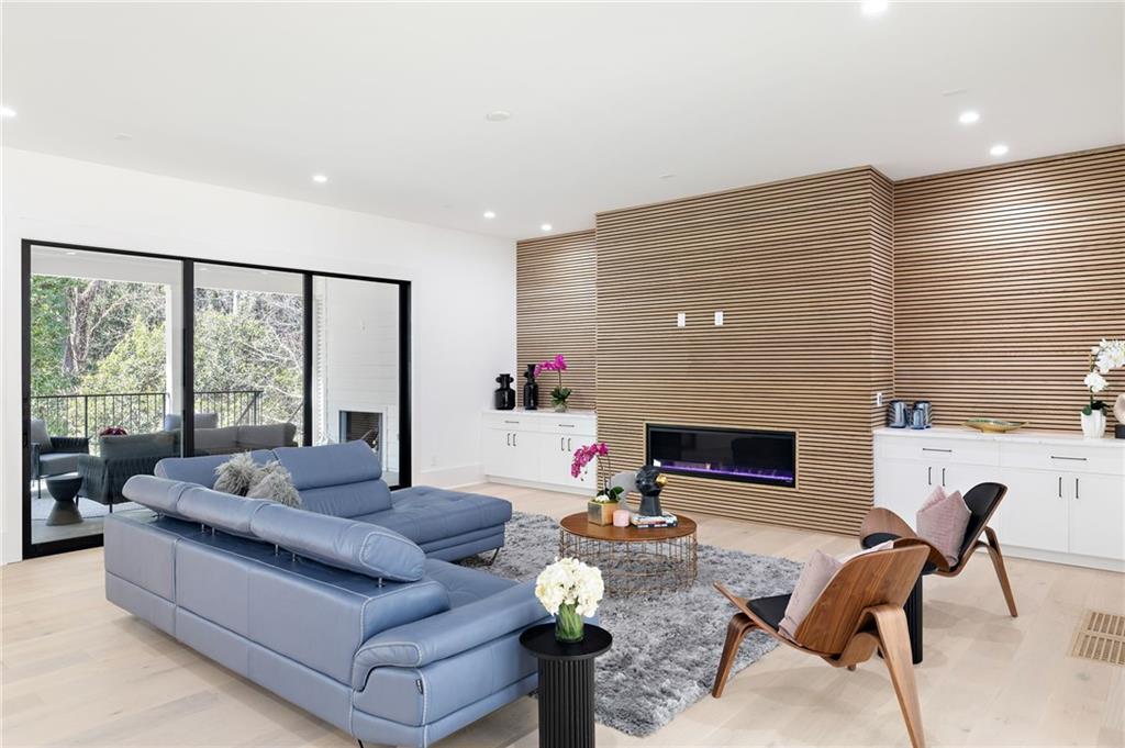 Inside, you'll discover a blend of luxury features, including high ceilings, oversized windows, wide plank hardwood flooring, designer lighting, custom cabinetry, and contemporary finishes.